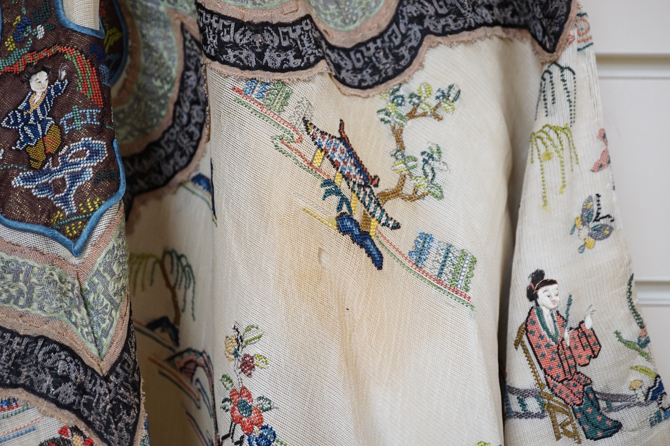 A late 19th/early 20th century Chinese gauze summer robe embroidered with flowers, figures and pagodas, 85cm high